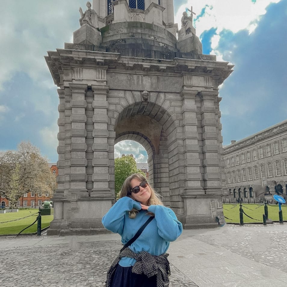 Maria standing in front of the Campanile at Trinity College Dublin